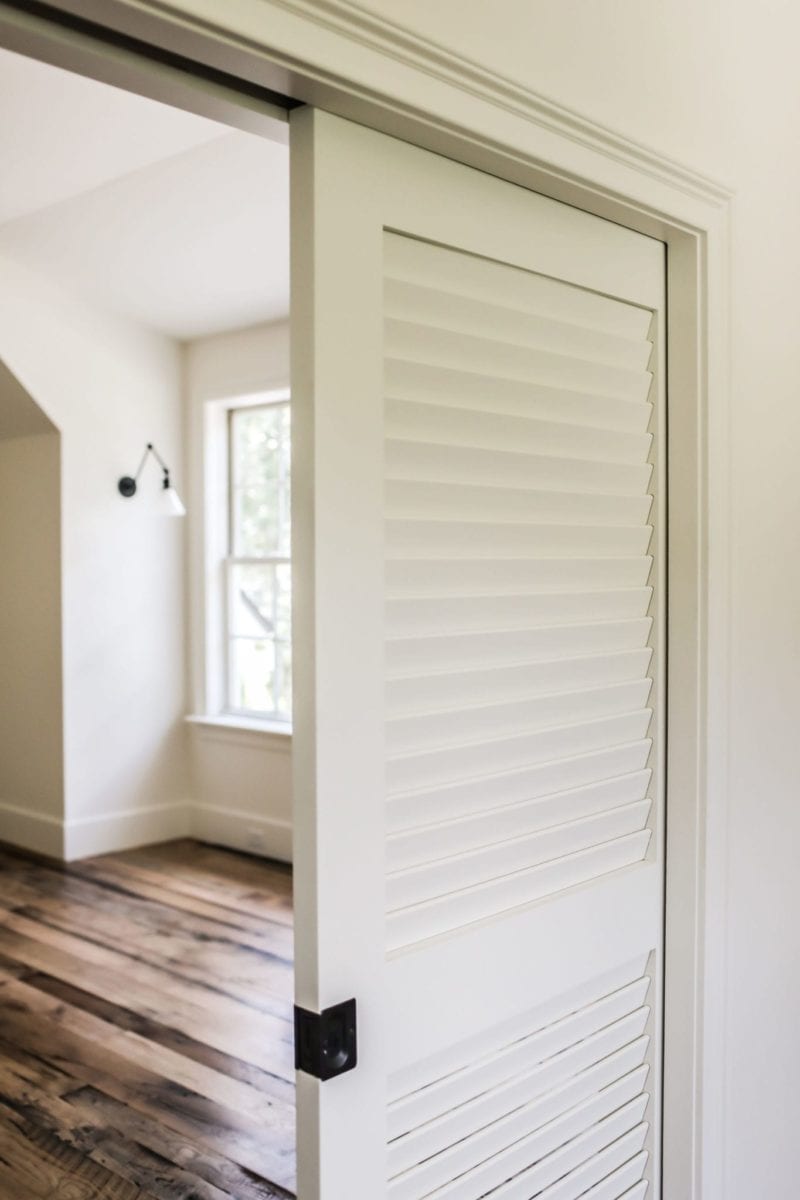 Sliding louvered pocket door