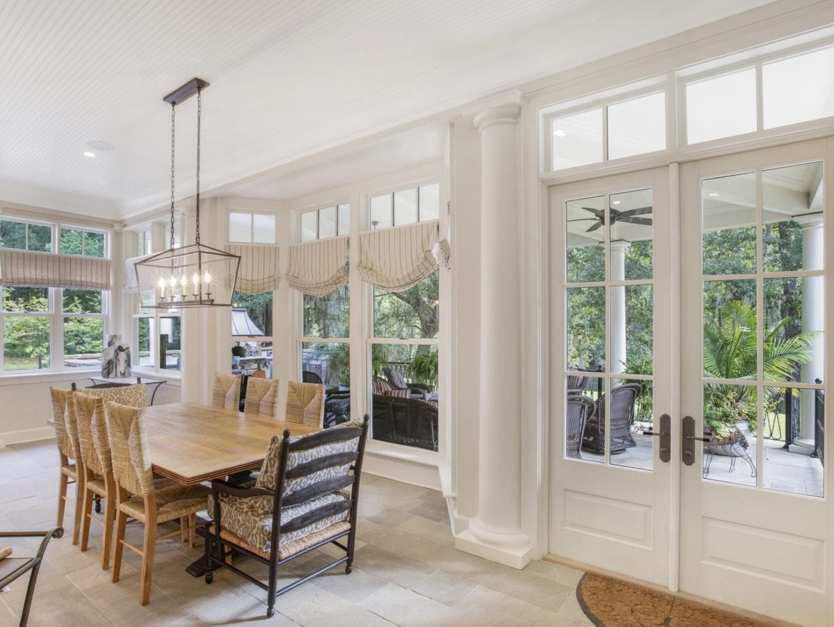 Eat-in kitchen renovation with stone floors leading to new outdoor covered patio