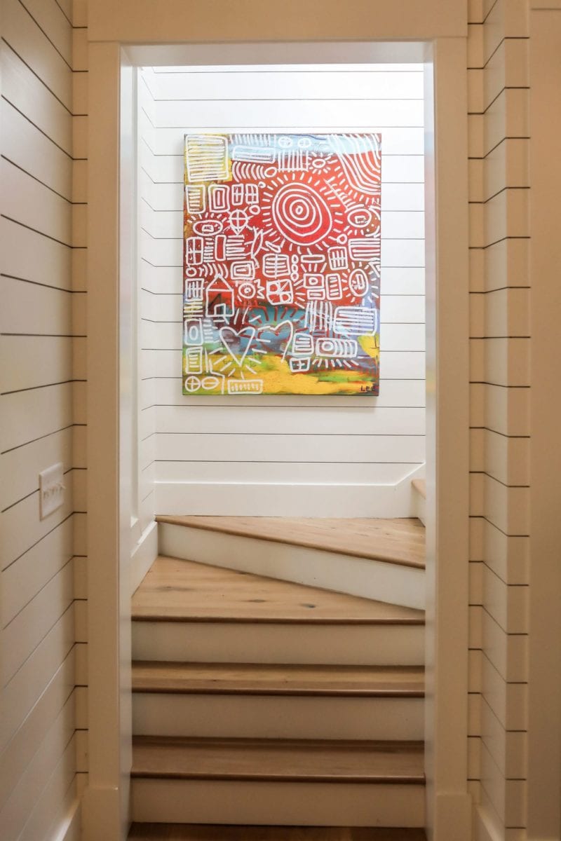 Stairwell to upper level with modern artwork