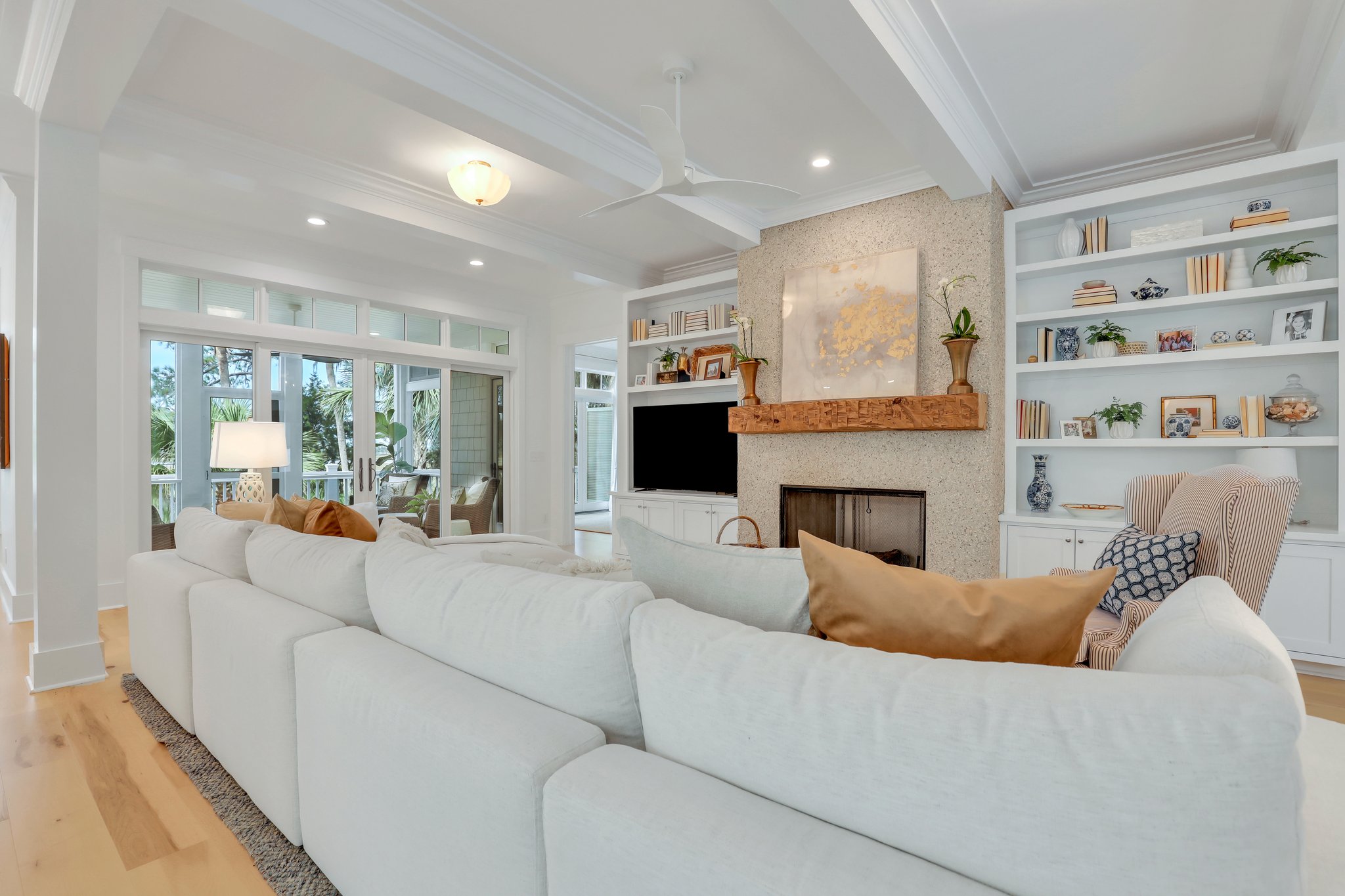 Living room at center of home floor plan in coastal home with low country elegance